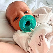 Stetson is registered to the contest to win money with this photo: baby, newborn, pacifier, blanket, onesie, animal_print, infant, face, expression, closeup, skin, lying_down, cute, sleepwear, child, baby_clothes, comfort, indoors, resting, soft