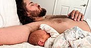 Stetson joined the competition — help win amazing prizes! man, baby, sleeping, bed, blanket, indoor, lamp, door, beard, rest, cozy, father, child, family, home, skin, person, relaxation, comfort, napping