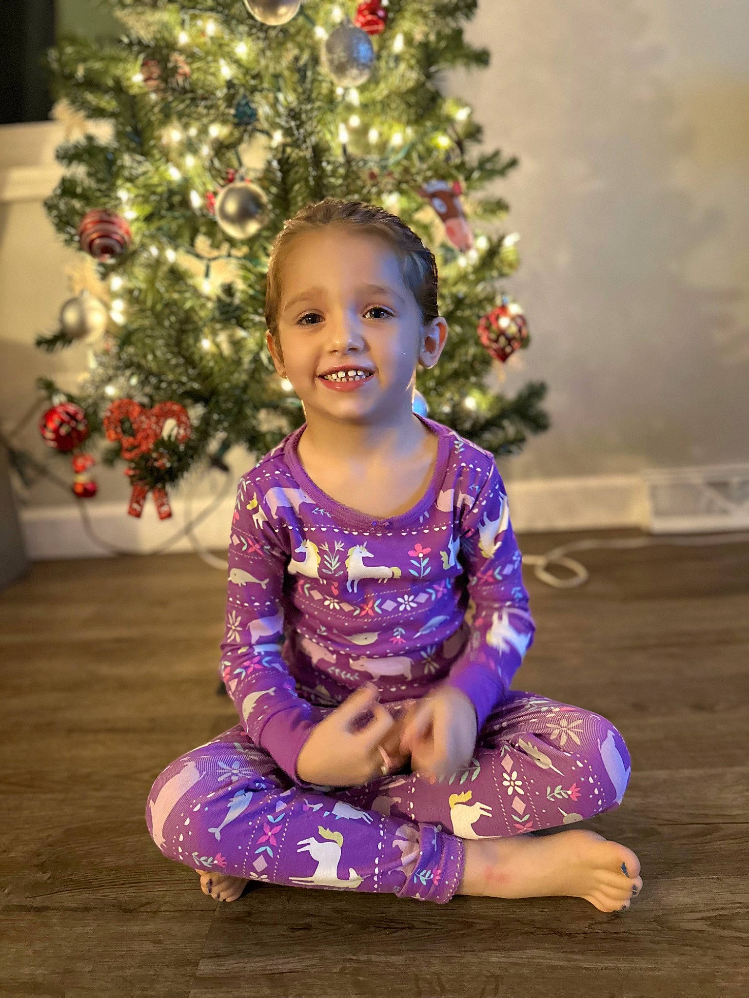 Paiselynn is registered to the contest to win money with this photo: baby_toddler_clothing, beauty, child, christmas_decoration, christmas_ornament, christmas_tree, event, eye, fun, happy, holiday_ornament, human_body, joy, ornament, person, plant, purple, sleeve, smile, standing