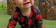 Nevaeh joined the competition — help win amazing prizes! baby, background, black_clothing, child, closeup, crawling, curious, cute, green_turf, happy, indoor, interactive_panel, person, play_area, playful, portrait, red_flowers, smiling, toddler, wooden_stumps