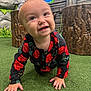 baby, background, black_clothing, child, closeup, crawling, curious, cute, green_turf, happy, indoor, interactive_panel, person, play_area, playful, portrait, red_flowers, smiling, toddler, wooden_stumps