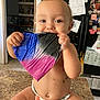 Nevaeh is registered to the contest to win money with this photo: baby, candid, chewing, child, counter, cute, diaper, face, hands, happy, home, indoor, infant, kitchen, magnets, papers, plastic_bag, refrigerator, sitting, smiling