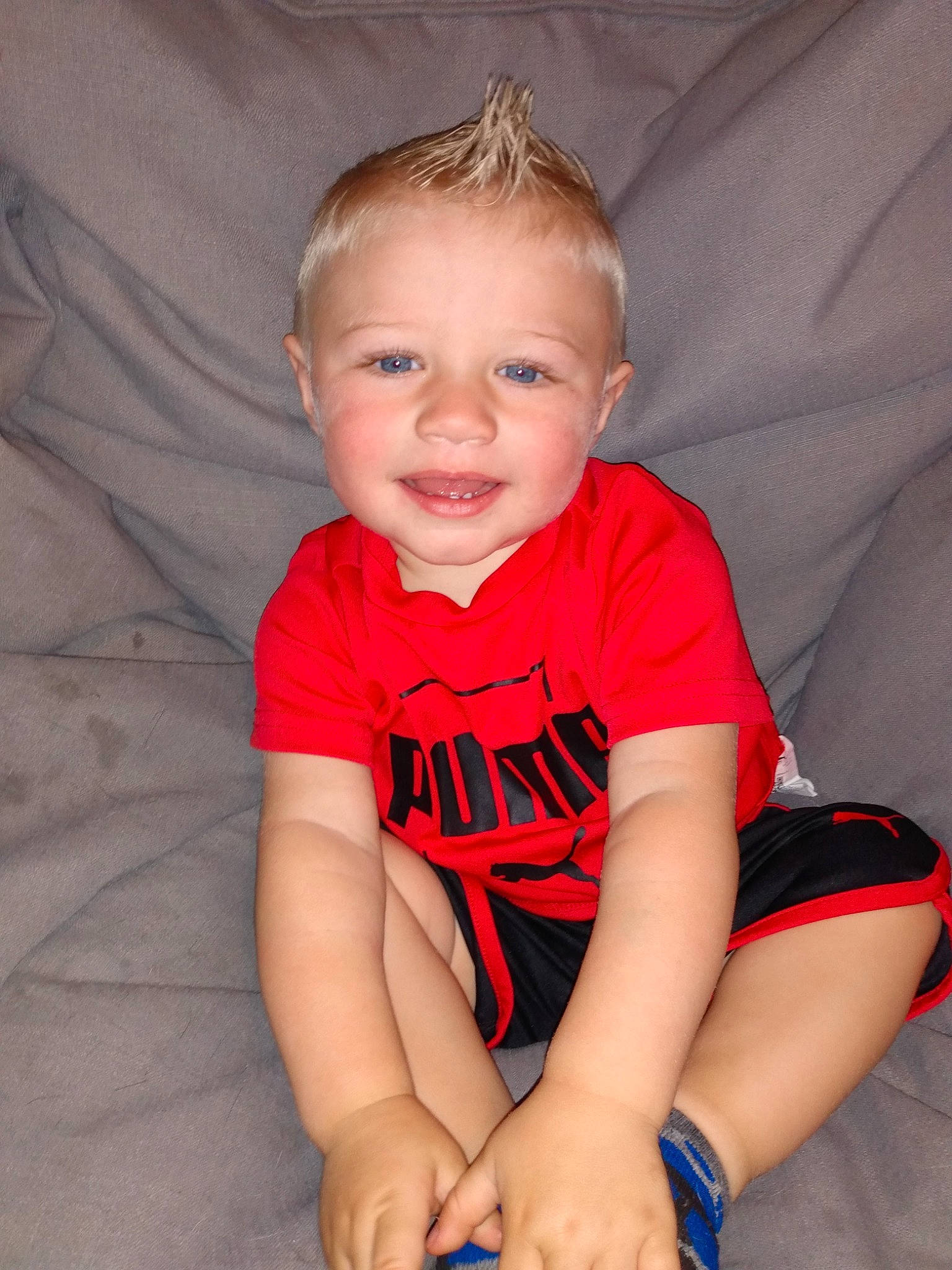 Chevy is registered to the contest to win money with this photo: arm, baby_toddler_clothing, cheek, comfort, face, finger, flash_photography, hair, happy, head, joy, knee, leg, lip, mouth, neck, person, skin, sleeve, smile