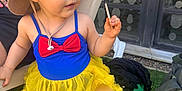 Gina participe au concours pour gagner de l'argent avec cette photo : accessories, baby, bracelet, clothing, costume, cream, dress, face, footwear, hat, head, jewelry, person, photography, portrait, sandal, shoe, skirt, summer, sunhat