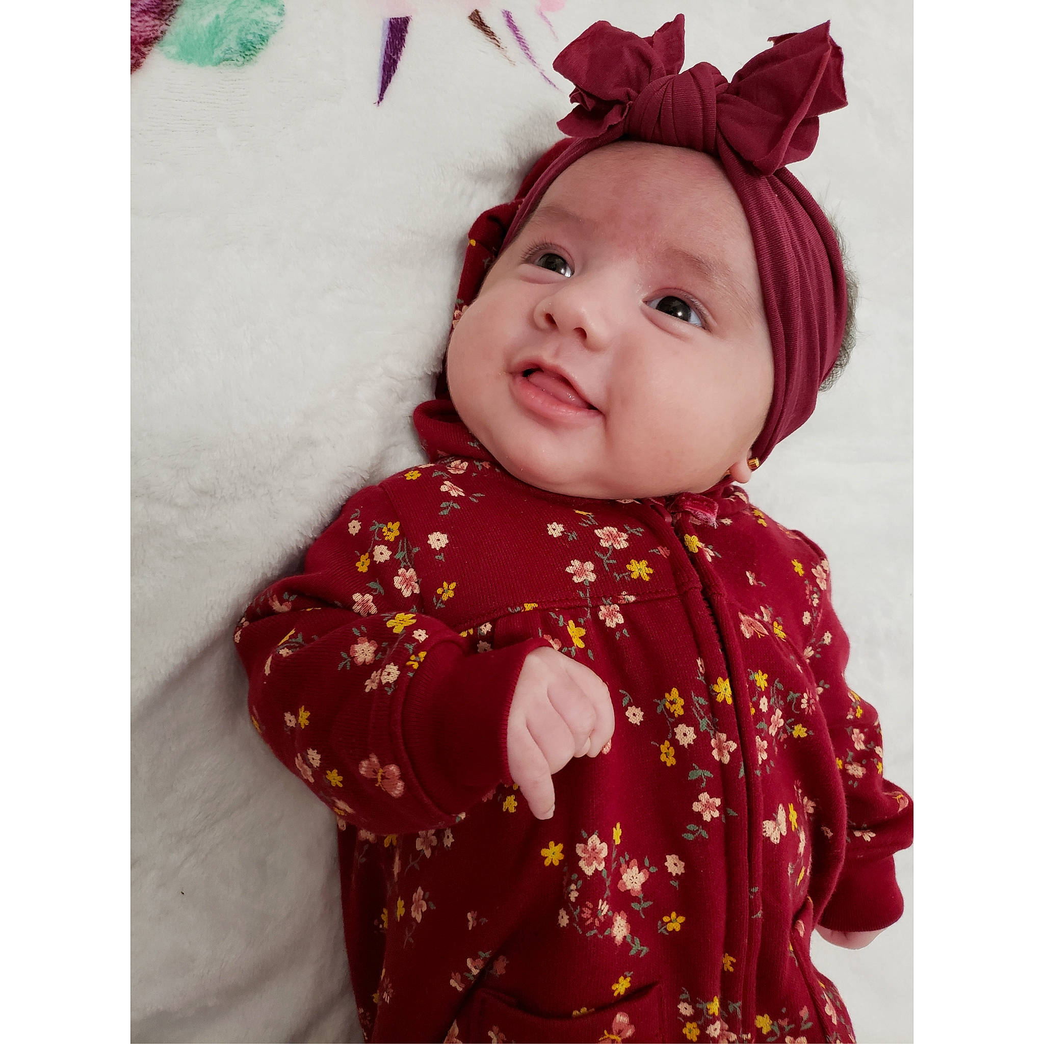 Lucia is registered to the contest to win money with this photo: baby, cheek, child, clothing, design, ear, face, head, headgear, headwear, hood, lip, maroon, outerwear, pattern, person, pink, product, red, sleeve