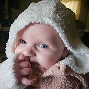 Kara joined the competition — help win amazing prizes! baby, infant, child, hood, blanket, hand, thumb, face, blue_eyes, soft_texture, warm_clothing, indoor, portrait, cute, closeup, cozy, newborn, person, sitting, wrapped