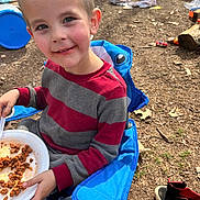 Jeremiah joined the competition — help win amazing prizes! child, boy, outdoor, smiling, chair, blue_chair, plate, food, sweater, red_and_gray, toy, slide, shoes, mickey_mouse, ground, dirt, playground, happy, face, person