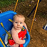 baby, blue_swing, child, cute, diaper, dirt_ground, grass, infant, nature, outdoor, person, play, playground, red_safety_bar, rope, seat, swing, toddler, trees, yellow_rope