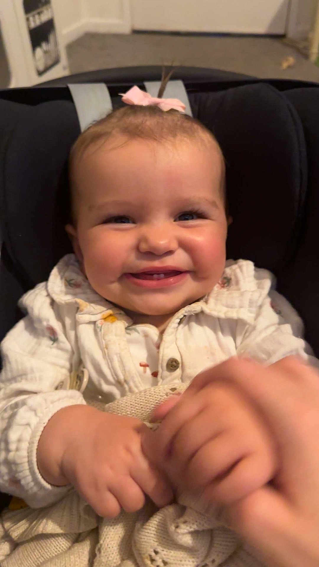 Melody-Rose joined the competition — help win amazing prizes! baby, smile, child, infant, hands, blanket, bow, cute, happy, indoor, clothing, person, portrait, seated, closeup, face, cheeks, button, knitwear, warm