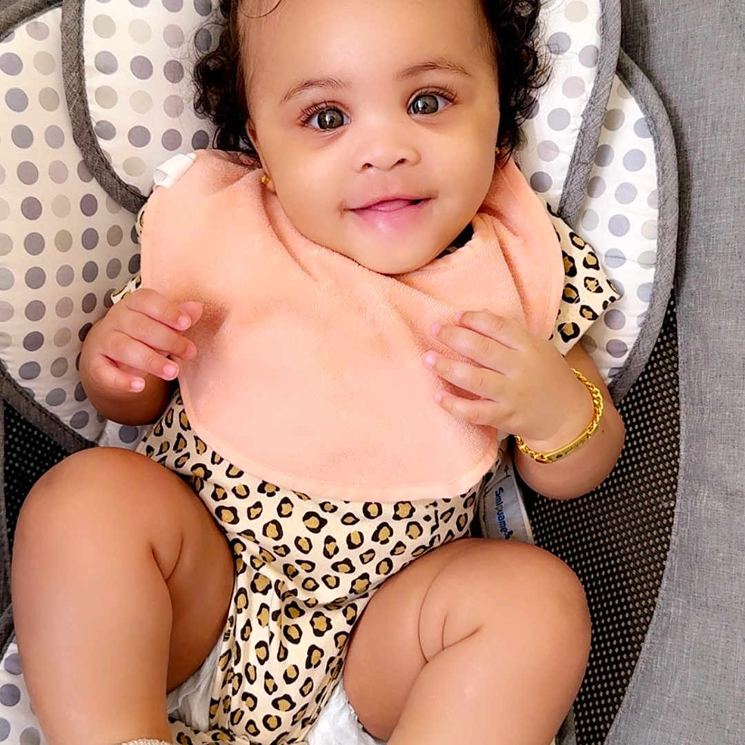 Sariyah joined the competition — help win amazing prizes! accessories, baby, bodypart, clothing, cushion, diaper, dress, face, finger, furniture, hand, happy, head, hosiery, person, photography, portrait, sitting, smile, sock