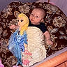 Aerith joined the competition — help win amazing prizes! baby, infant, child, doll, elsa_doll, playpen, blanket, floral_pattern, sitting, lying_down, portrait, face, eyes, hands, black_shirt, white_blanket, toy, indoor, cozy, family_photo