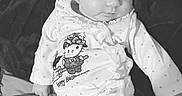 Aerith joined the competition — help win amazing prizes! baby, infant, child, portrait, sitting, hello_kitty, halloween, bow, headband, onesie, star_pattern, clothing, bed, blanket, indoor, black_and_white, face, serious_expression, cute, photograph