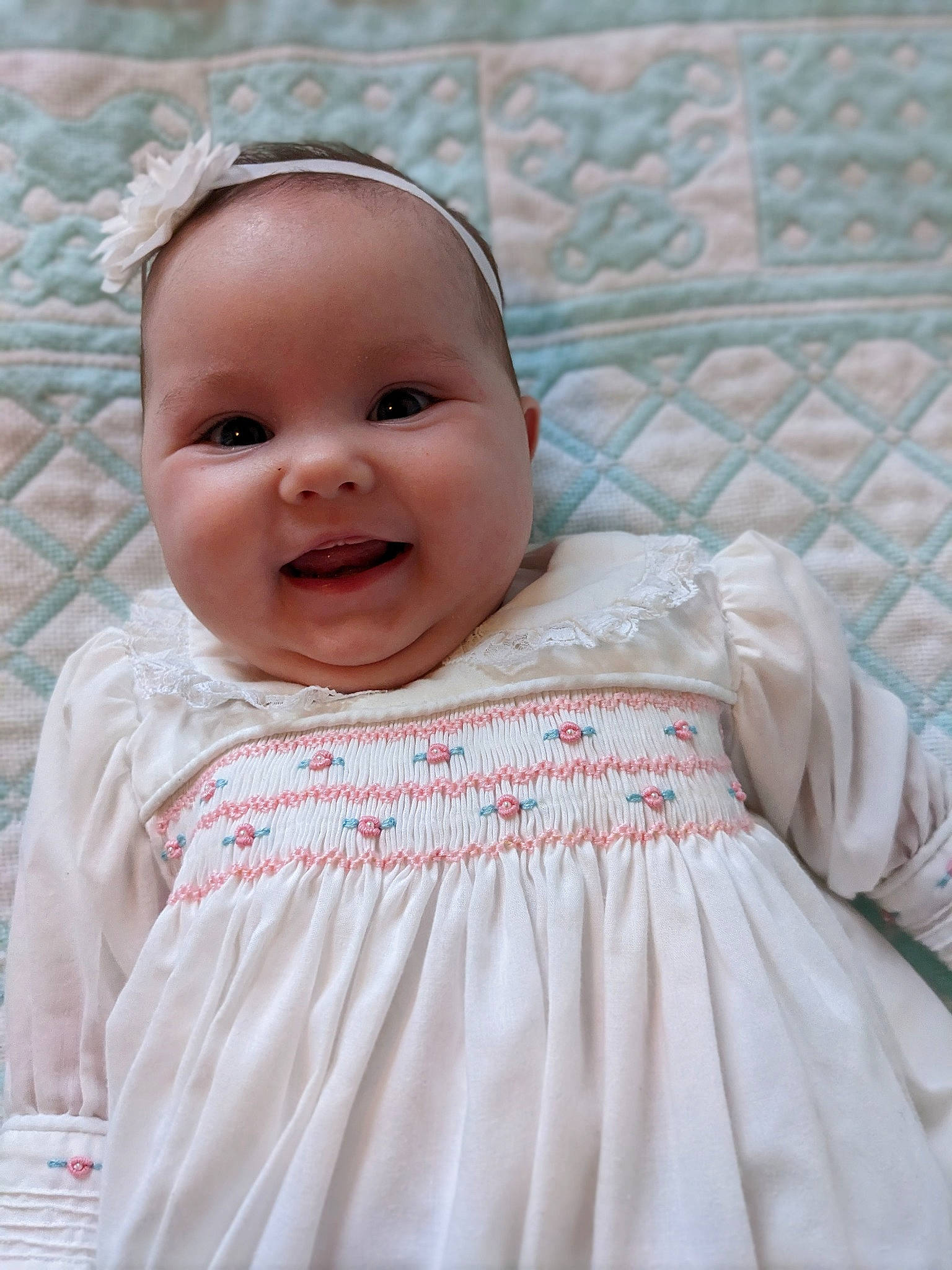 Lily is registered to the contest to win money with this photo: baby, baby_toddler_clothing, cheek, child, chin, day_dress, embellishment, eye, face, happy, iris, linens, one_piece_garment, pattern, person, pink, skin, sleeve, smile, textile