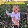 toddler, child, outdoor, grass, swing, bubbles, happy, smiling, white_shirt, camouflage_shorts, sandals, sunlight, playground, nature, fun, joy, person, portrait, summer, daytime
