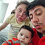 Anthony joined the competition — help win amazing prizes! child, baby, man, glasses, indoor, selfie, striped_clothing, curly_hair, casual, portrait, family, person, bedroom, red_clothing, yellow_shirt, looking_at_camera, facial_expression, closeup, playful, young