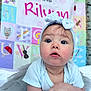 Rilynn joined the competition — help win amazing prizes! baby, child, infant, headband, blue, cute, face, eyes, hands, skin, clothing, tutu, quilt, alphabet, background, colorful, soft, portrait, indoors, expression
