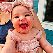 Rilynn joined the competition — help win amazing prizes! baby, child, smiling, pink_bow, pink_clothing, tattoo, adult_hand, woman, window, home, outdoor, happy, portrait, face, cheerful, cute, person, skin, holding, sleeveless