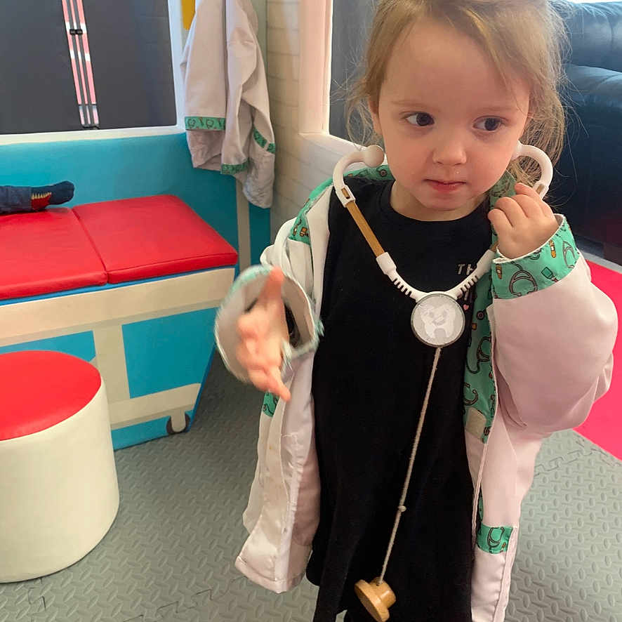 Michaela is registered to the contest to win money with this photo: bench, bodypart, child, clothing, coat, costume, face, female, finger, furniture, girl, hand, head, indoors, interiordesign, longsleeve, person, photography, portrait, sleeve