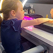 Michaela is registered to the contest to win money with this photo: child, girl, salon, manicure, nail_polish, ring_light, chair, table, beauty, personal_care, indoor, side_view, hair_tied, concentration, young, skin, hand, furniture, cosmetics, lighting