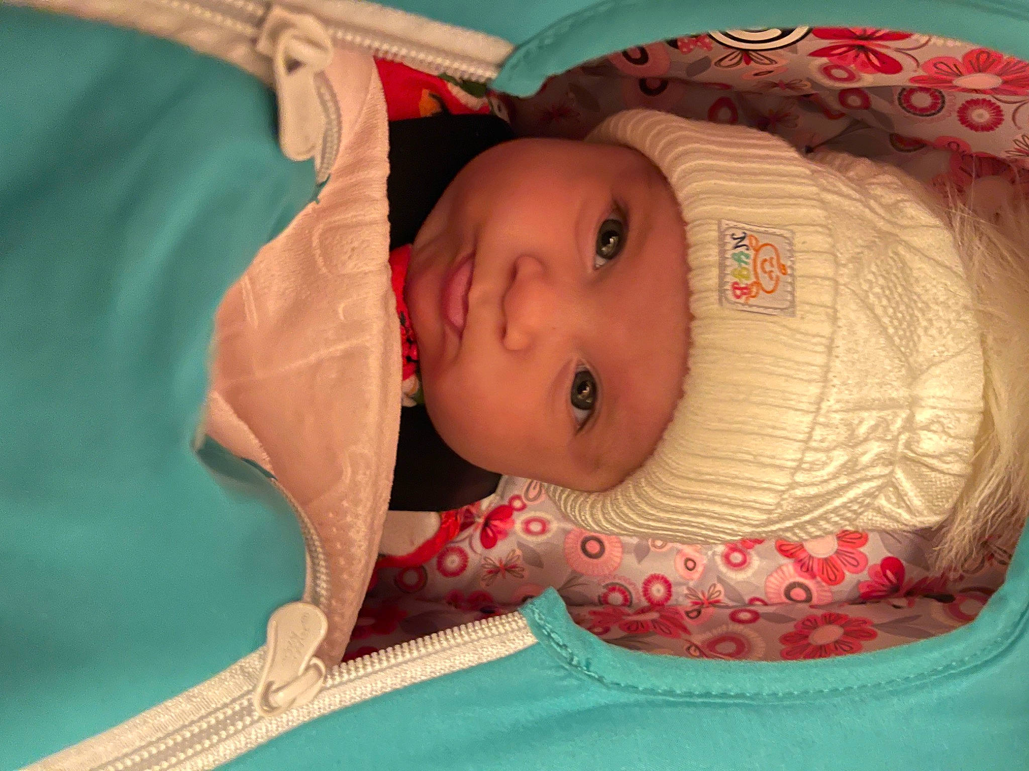 Jaycee is registered to the contest to win money with this photo: baby, baby_toddler_clothing, cheek, child, chin, eye, eyebrow, eyelash, face, head, headgear, headwear, human_body, infant_bed, iris, mouth, nose, person, pink, skin