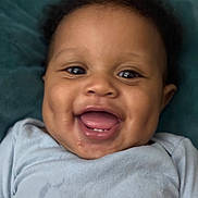 Kaizen joined the competition — help win amazing prizes! baby, smiling, closeup, face, infant, blue_shirt, happy, cute, child, portrait, skin, eyes, mouth, teeth, drool, dimples, hair, laying, background, expression