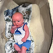 Joseph joined the competition — help win amazing prizes! baby, infant, blanket, blue_shorts, white_shirt, animal_print, basin, indoor, cute, child, clothing, person, skin, head, feet, hand, expression, resting, portrait, newborn