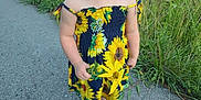 Serenity is registered to the contest to win money with this photo: child, smiling, sunflower_dress, pink_shoes, flower, outdoor, grass, trees, path, nature, happy, toddler, sunlight, greenery, casual_clothing, portrait, daytime, cute, person, small_child