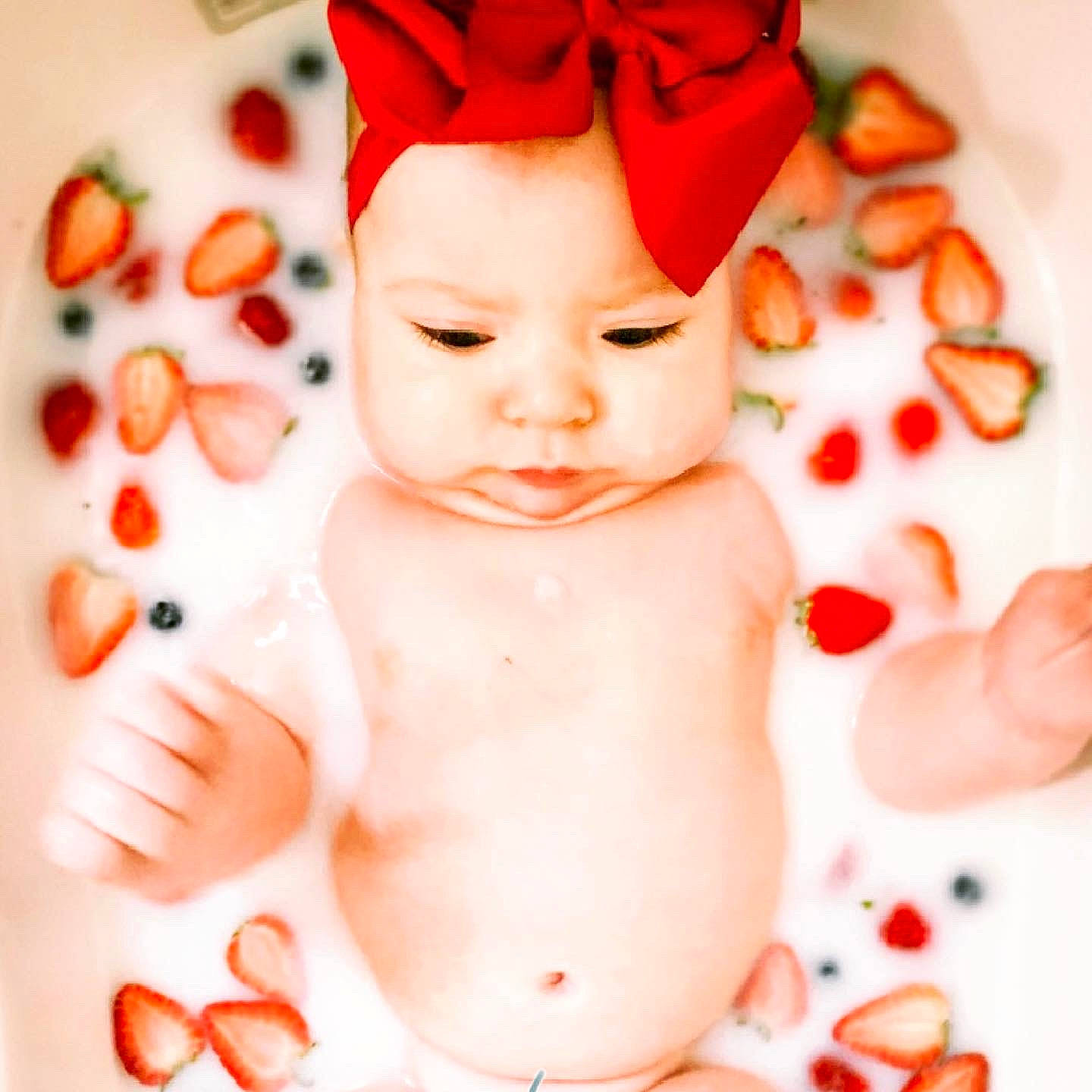 Lennox is registered to the contest to win money with this photo: baby, cheek, child, headwear, orange, person, petal, plant, red, skin, toddler