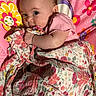 Athena joined the competition — help win amazing prizes! baby, infant, child, portrait, face, eyes, smiling, lying_down, blanket, floral, pink, colorful, bed, bedding, clothing, short_sleeves, indoors, close_up, happy, photography