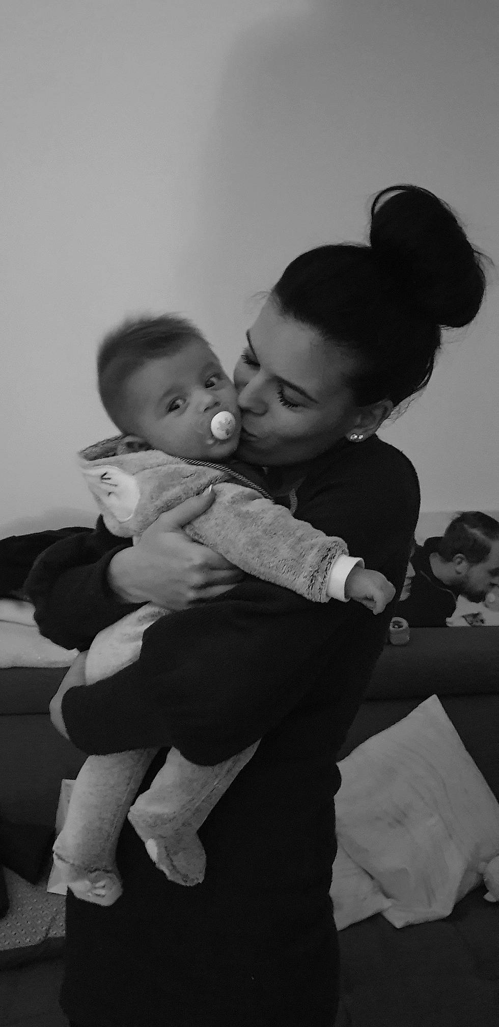 Ilan participe au concours pour gagner de l'argent avec cette photo : arm, baby, black, black_and_white, cheek, child, eye, happy, hug, interaction, monochrome, monochrome_photography, people, person, photograph, photography, smile, snapshot, standing, toddler