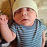 newborn, baby, infant, sleeping, portrait, face, onesie, striped_clothing, knit_hat, beanie, tiny_hand, fist, blanket, cozy, indoors, close_up, peaceful, cuddly, photography, watermark
