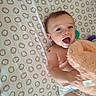 baby, infant, child, smiling, laughing, portrait, bed, bedding, hedgehog_pattern, stuffed_animal, teddy_bear, plush_toy, diaper, lying_down, indoor, nursery, happy, face, skin, text_overlay