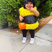 Liam joined the competition — help win amazing prizes! child, toddler, halloween, bee_costume, pumpkin_bucket, smile, laughing, outdoors, evergreen_tree, sidewalk, sneakers, white_shoes, black_clothing, yellow_fur, hat, trick_or_treat, cute, standing, portrait, candy_bucket