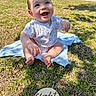 baby, infant, eight_months, grass, outdoor, smiling, happy, sunlight, blanket, milestone, sign, child, cute, portrait, sitting, casual, clothing, nature, daylight, joyful