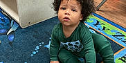 Castiel joined the competition — help win amazing prizes! child, toddler, curly_hair, sitting, carpet, water_bottle, classroom, blocks, toy, floor, green_clothing, indoor, young_child, person, play_area, colorful, educational, furniture, chair, wood_floor