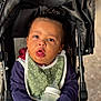Castiel is registered to the contest to win money with this photo: toddler, child, baby, stroller, bottle, bib, clothing, face, hand, person, outdoor, expression, curious, seat, portrait, young_child, casual, warm_clothing, closeup, cute