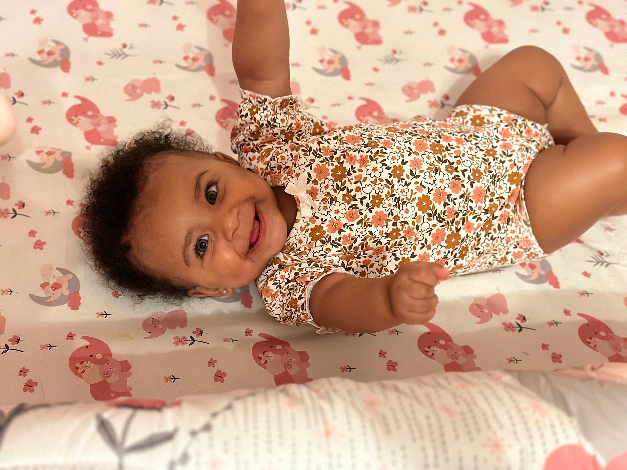 Aleyna joined the competition — help win amazing prizes! baby_toddler_clothing, bed, child, comfort, couch, face, happy, head, human_leg, joy, linens, pattern, person, pink, red, skin, sleeve, smile, textile, thigh