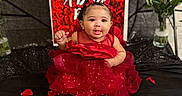 Aniree joined the competition — help win amazing prizes! baby, background, black_cloth, celebration, child, cute, decor, event, face, flower_vase, headband, indoor, jewelry, photography, portrait, red_dress, rose_petals, roses, sitting, smiling