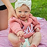 baby, blanket, bow, child, cute, diaper, feet, grass, hand, happy, headband, holding, infant, legs, outdoor, person, pink_sweater, playing, smile, support