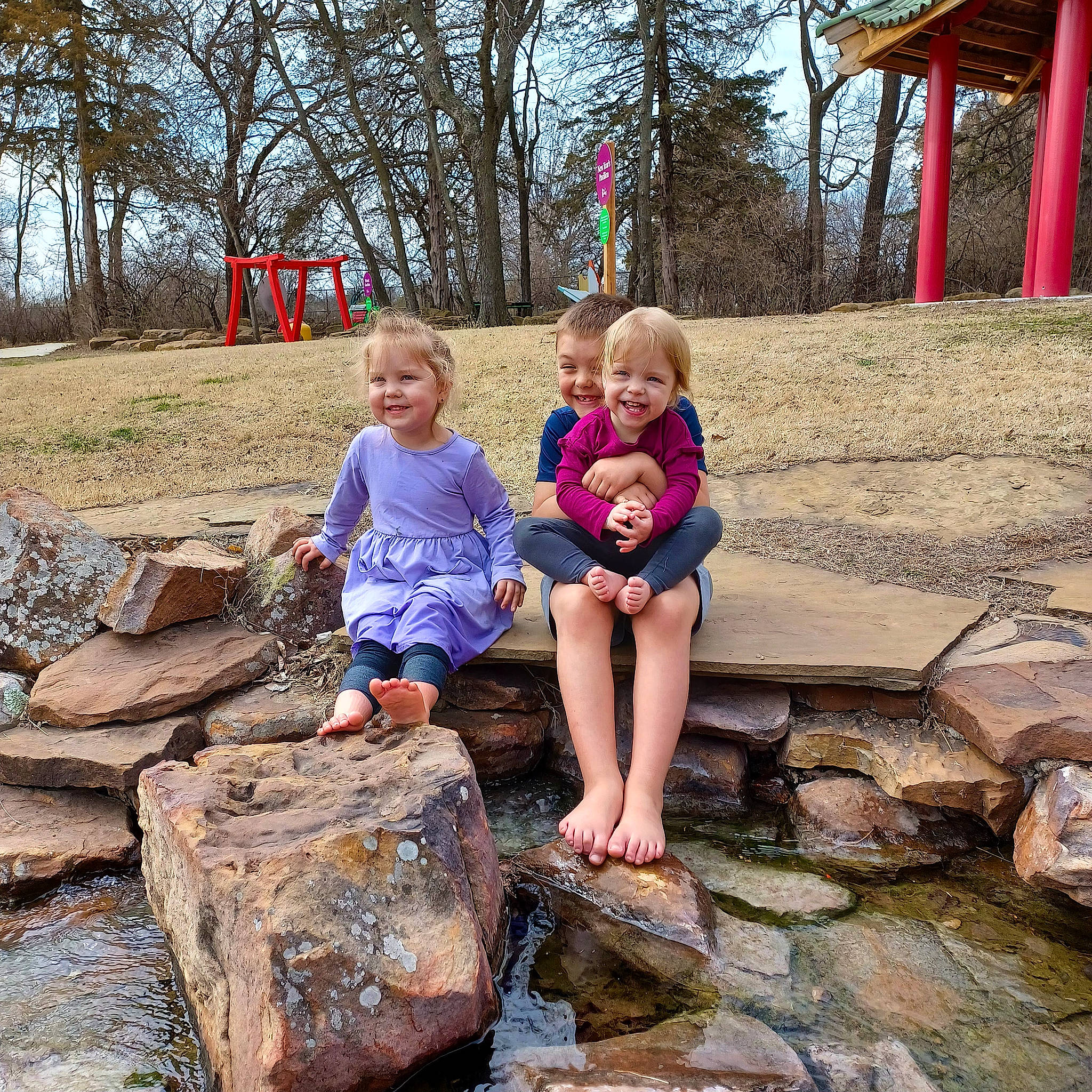 Lainey is registered to the contest to win money with this photo: bedrock, botany, child, fun, grass, happy, joy, landscape, leaf, leg, leisure, people_in_nature, person, plant, public_space, recreation, shorts, sitting, smile, toddler