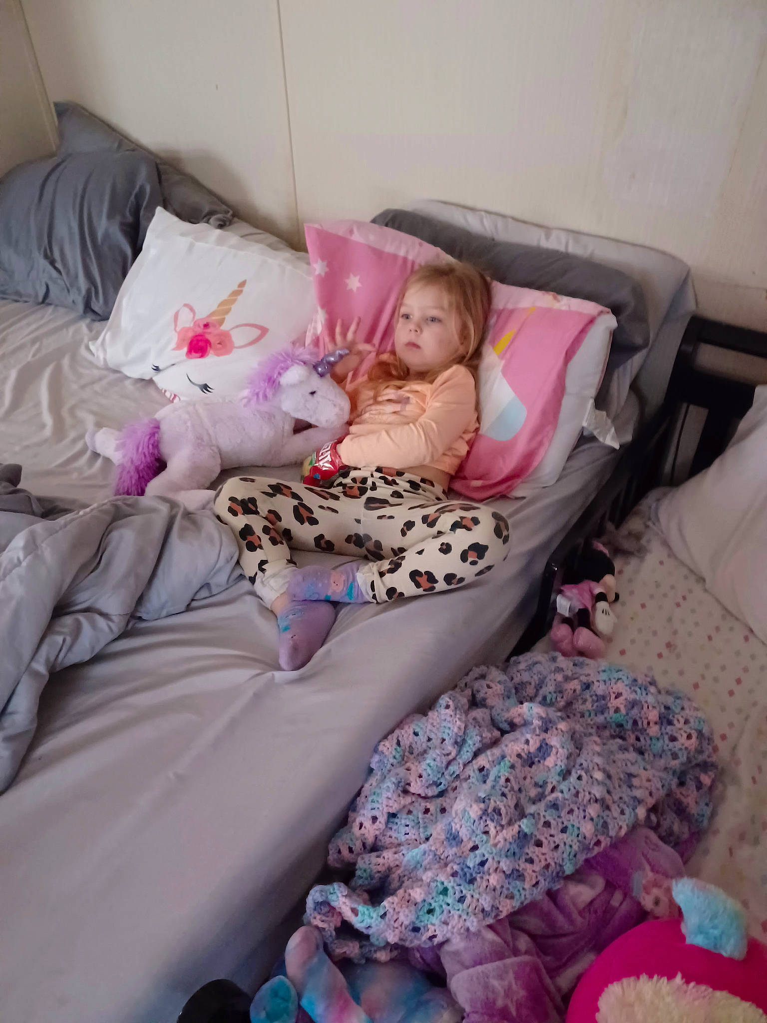 Lainey is registered to the contest to win money with this photo: baby_products, bed, bed_frame, bedding, bedroom, bedtime, comfort, dress, flooring, human_leg, leg, linens, magenta, pattern, person, pink, purple, sitting, textile, thigh