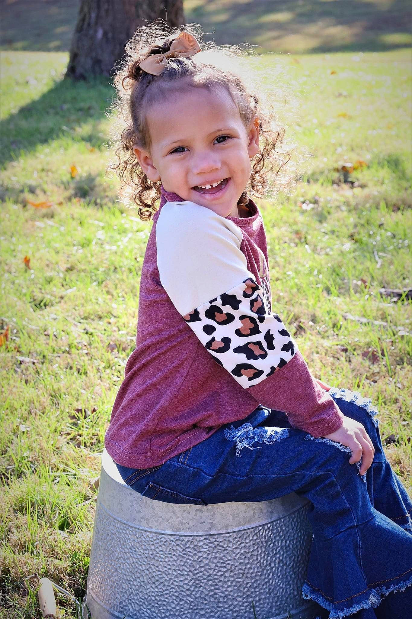 Calyn Rae is registered to the contest to win money with this photo: clothing, electric_blue, eye, face, flash_photography, grass, green, hairstyle, happy, head, joy, pattern, people_in_nature, person, photograph, plant, shoulder, sleeve, smile, toddler