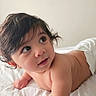 baby, infant, diaper, lying_down, bed, white_bed, curly_hair, dark_hair, cute, child, skin, portrait, indoor, soft_light, looking_away, closeup, happy, toddler, young_child, person