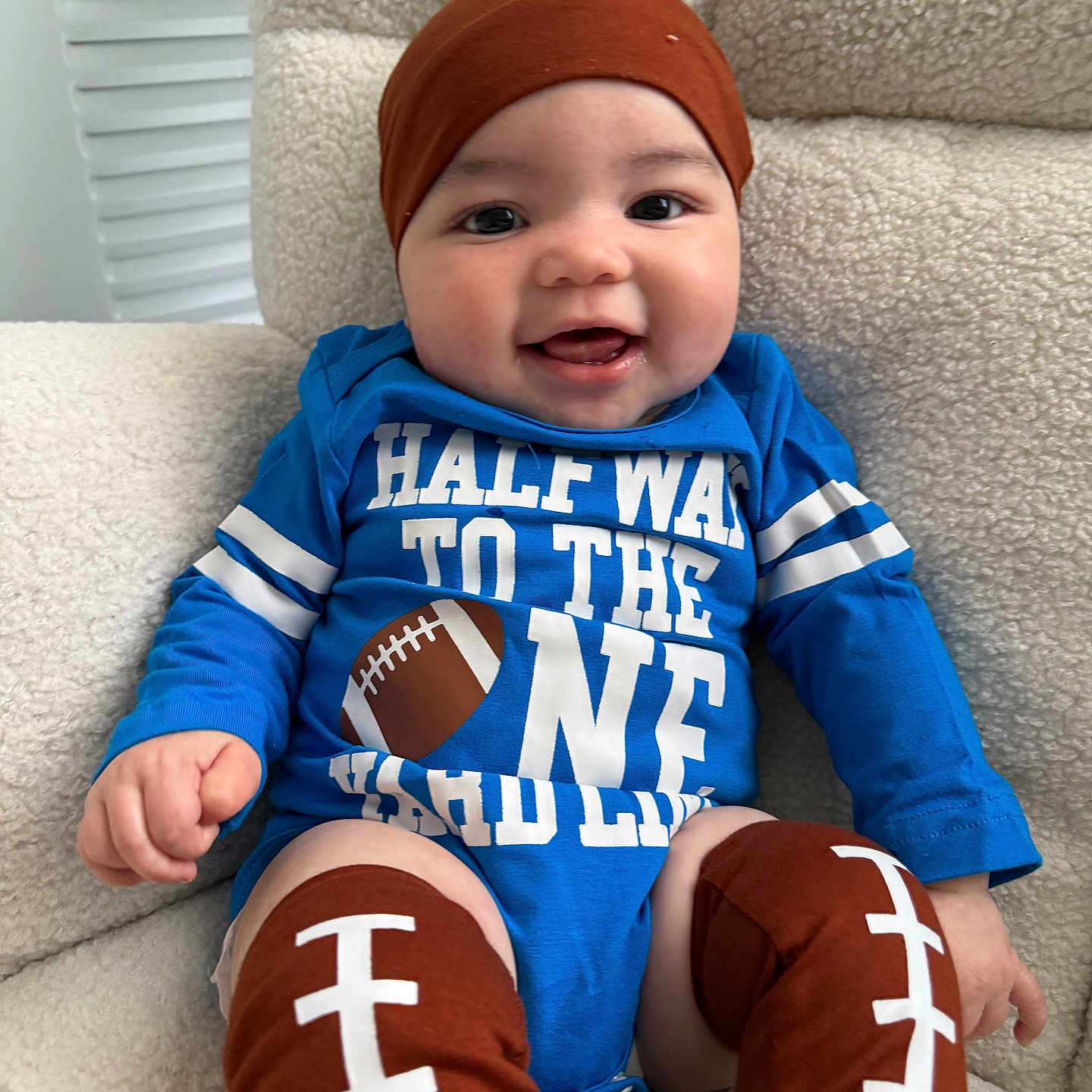 Xavier joined the competition — help win amazing prizes! baby, bodypart, cap, clothing, couch, cushion, face, finger, furniture, glove, hand, happy, hat, head, homedecor, pants, person, photography, portrait, sitting