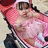 Daynelis joined the competition — help win amazing prizes! baby, child, stroller, pink, dress, headband, socks, blanket, outdoor, curious, cute, portrait, person, infant, seated, baby_girl, apparel, footwear, toddler, baby_stroller