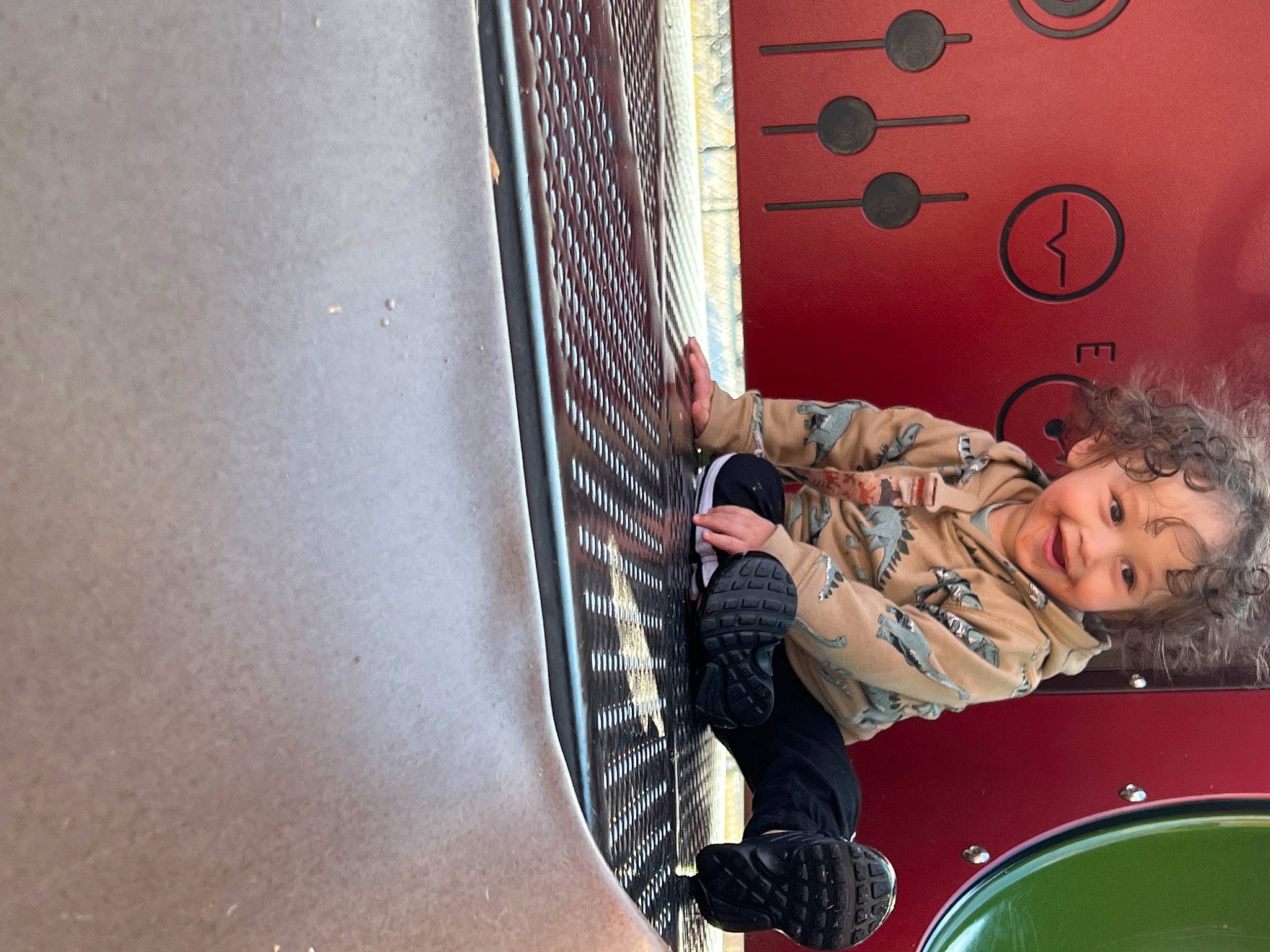 Brendan is registered to the contest to win money with this photo: child, fun, happy, joy, leisure, mesh, metal, net, pattern, person, playground, recreation, room, sitting, smile, toddler, visual_arts