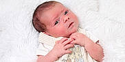Amelia joined the competition — help win amazing prizes! newborn, baby, infant, blanket, soft_texture, cute_outfit, embroidery, bunny, animal_design, curious, gazing, small_hands, skin_texture, lying_down, white_background, cozy, innocence, portrait, close_up, child