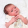 newborn, baby, infant, blanket, soft_texture, cute_outfit, embroidery, bunny, animal_design, curious, gazing, small_hands, skin_texture, lying_down, white_background, cozy, innocence, portrait, close_up, child