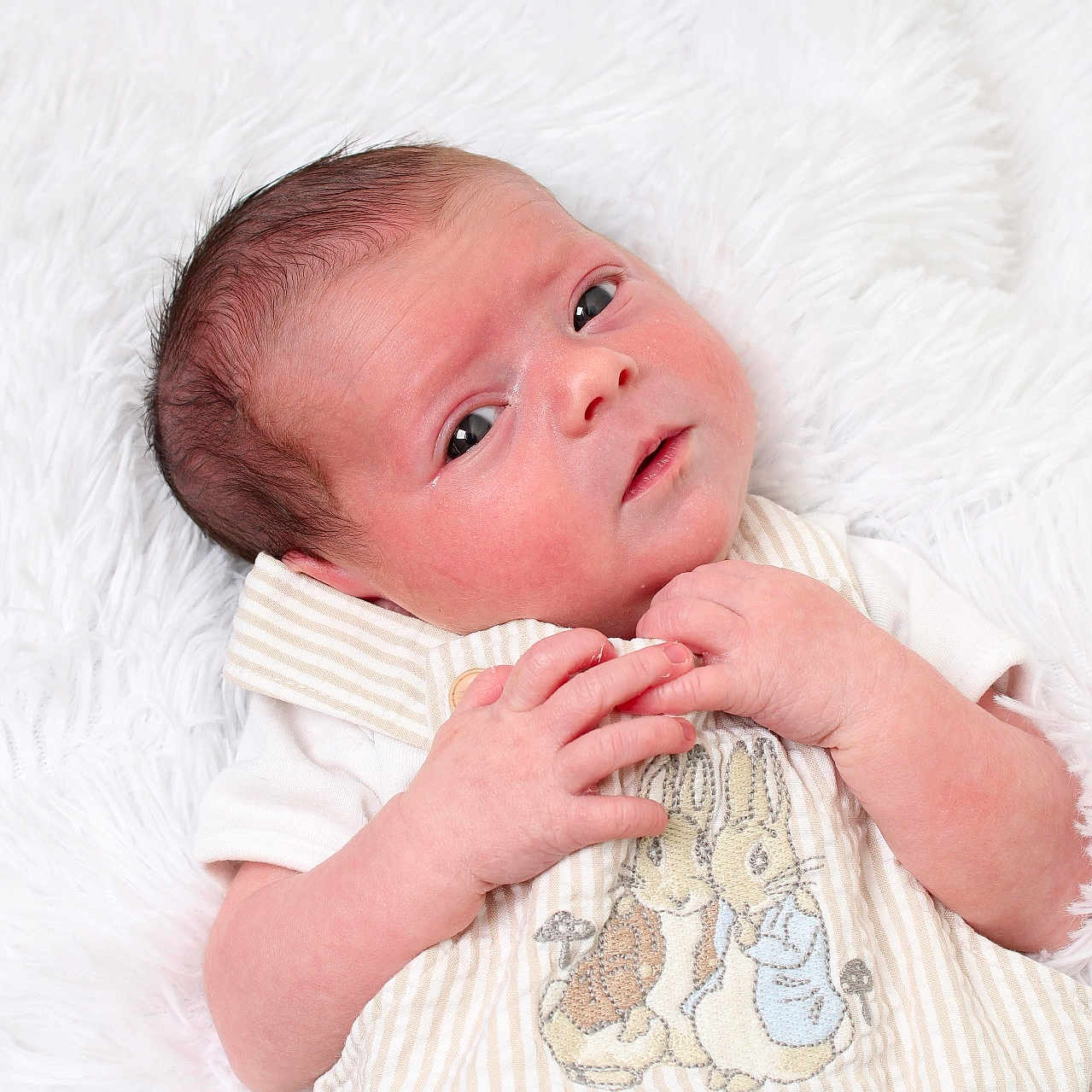 Amelia joined the competition — help win amazing prizes! animal_design, baby, blanket, bunny, child, close_up, cozy, curious, cute_outfit, embroidery, gazing, infant, innocence, lying_down, newborn, portrait, skin_texture, small_hands, soft_texture, white_background