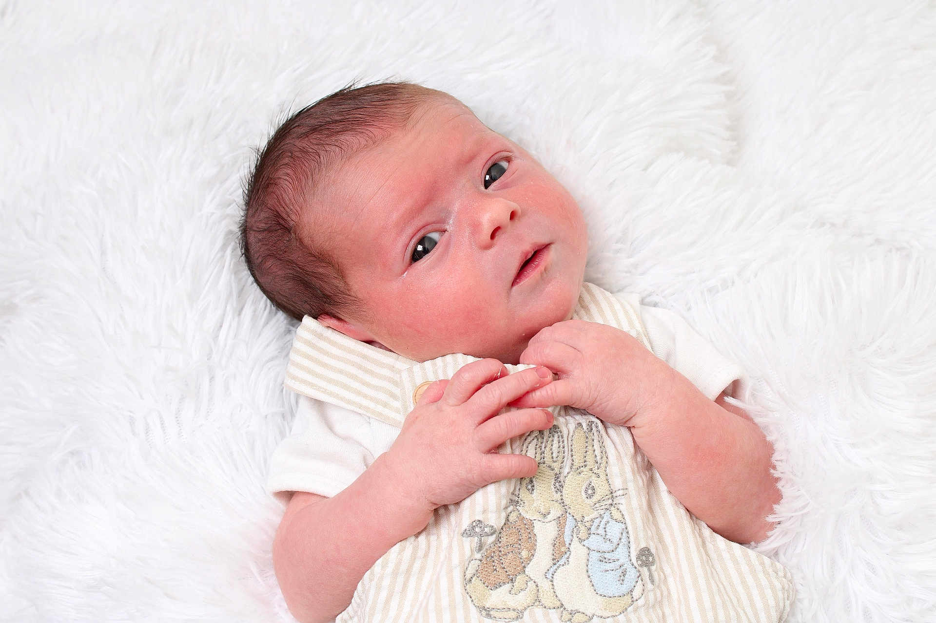 Amelia joined the competition — help win amazing prizes! newborn, baby, infant, blanket, soft_texture, cute_outfit, embroidery, bunny, animal_design, curious, gazing, small_hands, skin_texture, lying_down, white_background, cozy, innocence, portrait, close_up, child
